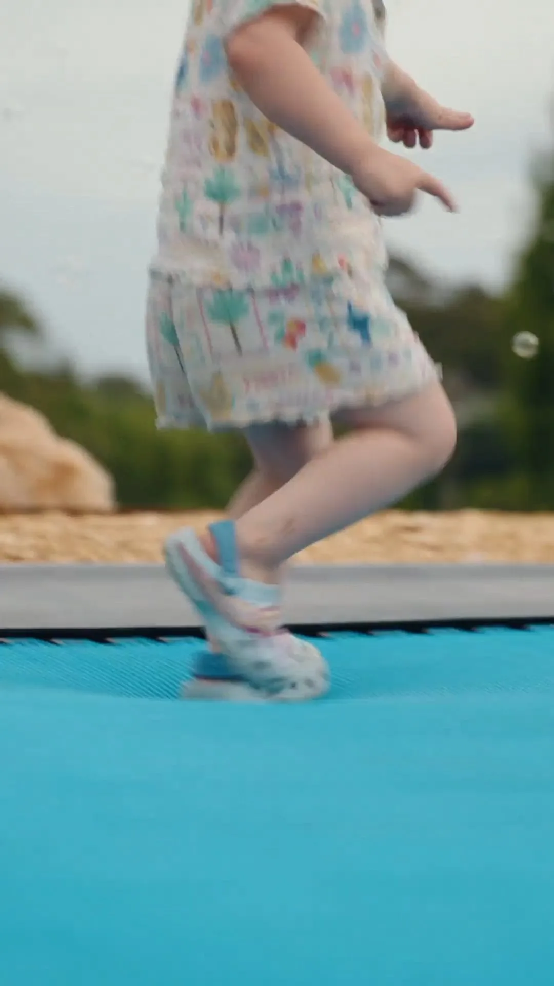 Child bouncing on an in-ground trampoline
